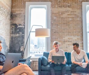 three men using MacBooks