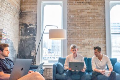 three men using MacBooks